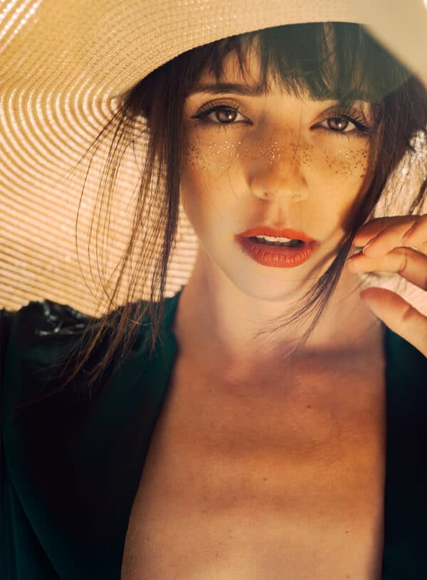 Omaha Cosmetic Center - A woman in a hat posing for a photo